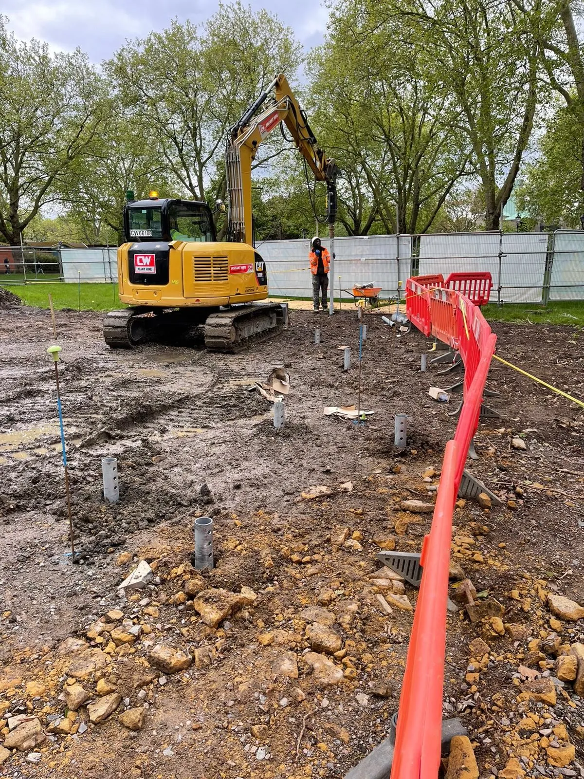 A construction site with construction equipment and workers.