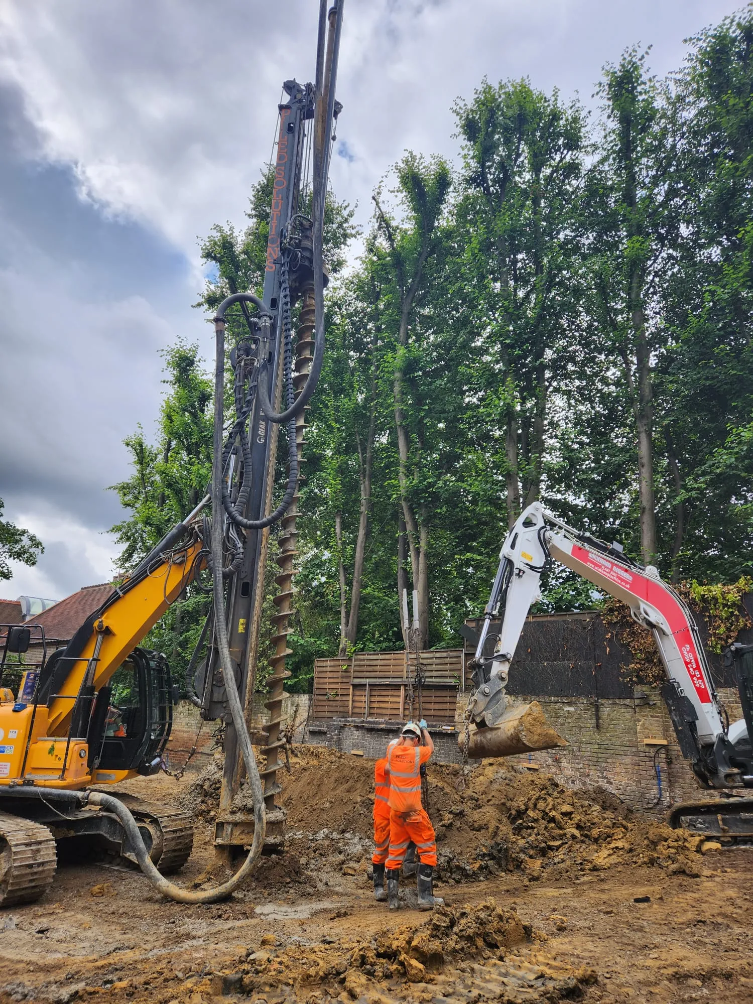 A man standing next to a pile of dirt.