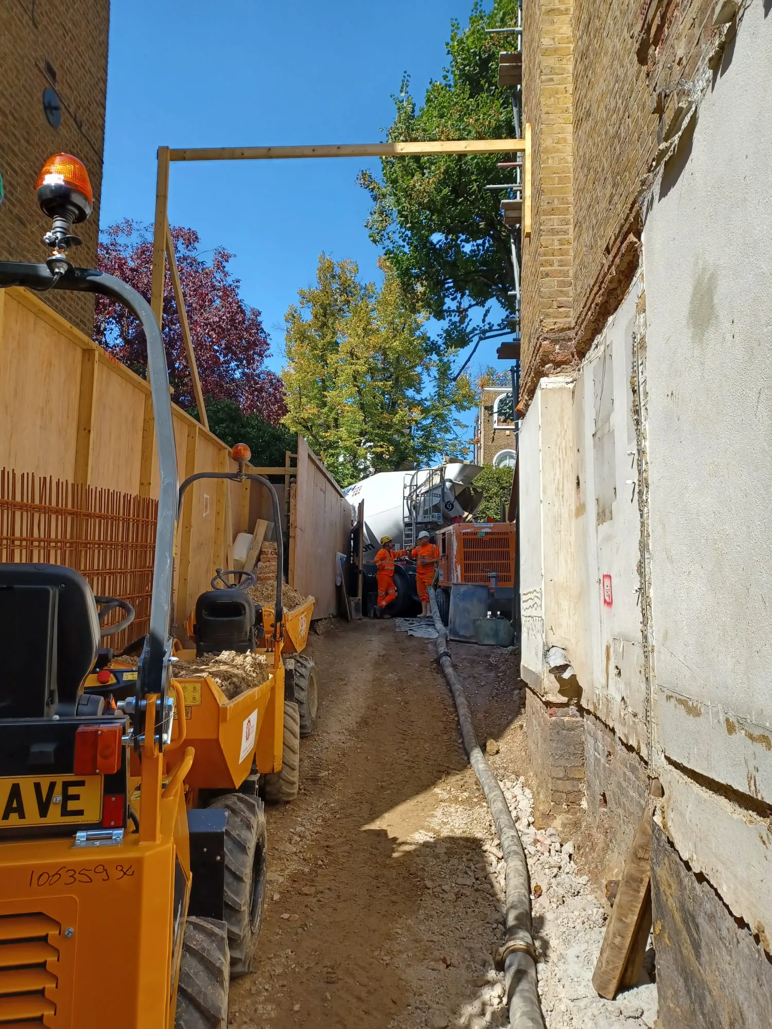 A street with construction equipment parked on the side of it.
