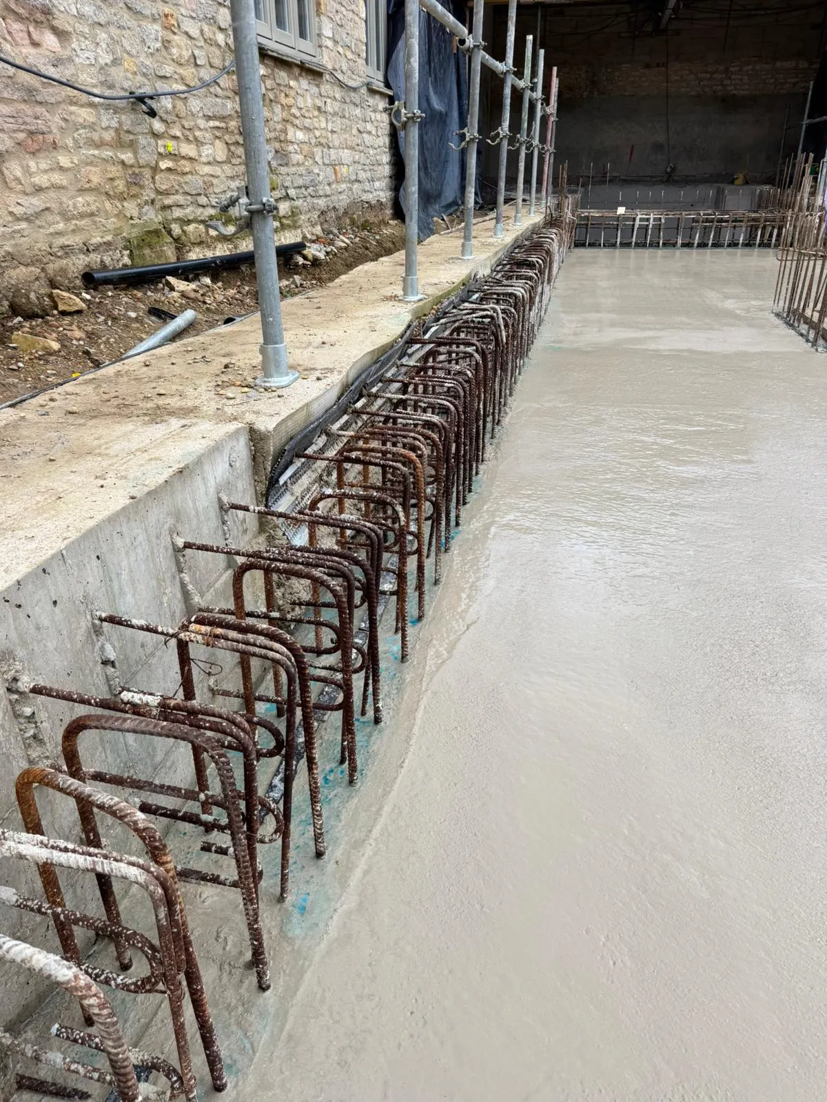 A row of metal bars sitting next to a building.